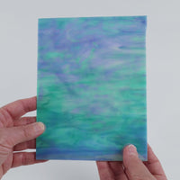 Video of the Soft Aqua Pearl glass plate in iridised translucent blue, 15x19cm, held up and tilted to show its pattern and transparency
