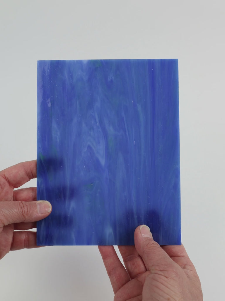 Video of the Hidden Depth glass plate in translucent blue, 15x19cm, held up and tilted to show its pattern and transparency