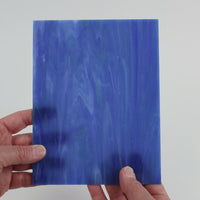 Video of the Hidden Depth glass plate in translucent blue, 15x19cm, held up and tilted to show its pattern and transparency
