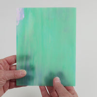 Video of the Aquamarine Pearl glass plate in iridescent translucent blue, 15x19cm, held up and tilted to show its pattern and transparency