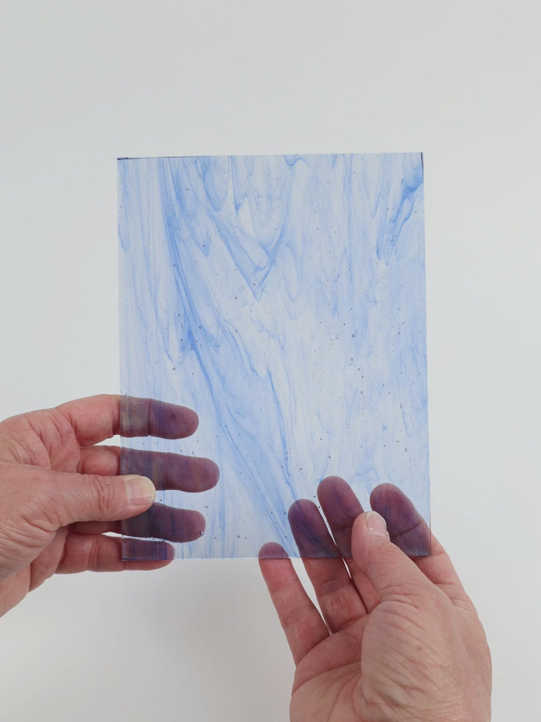 Video of the Light Blue Wispy glass plate in transparent blue, 15x19cm, held up and tilted to show its pattern and transparency