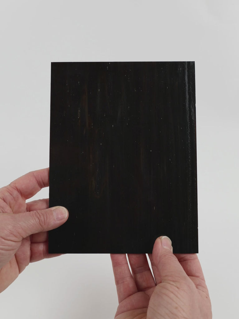 Video of the Tobacco glass plate in opaque brown, 15x19cm, held up and tilted to show its pattern and transparency