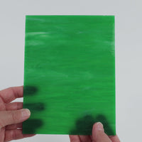 Video of the Green Opal glass plate in translucent green, 15x19cm, held up and tilted to show its pattern and transparency