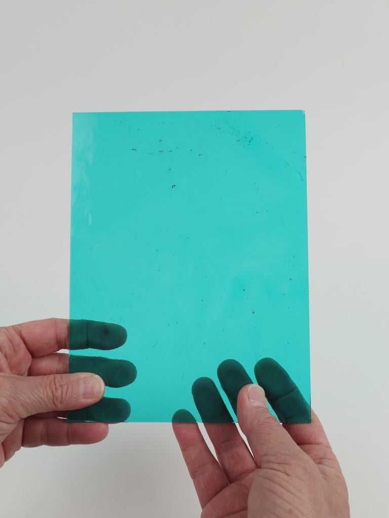 Video of the Aqua glass plate in transparent blue, 15x19cm, held up and tilted to show its pattern and transparency