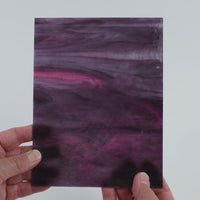 Video of the Violet Magenta Wispy glass plate in translucent purple, 15x19cm, held up and tilted to show its pattern and transparency