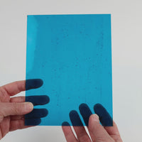 Video of the Clear Turquoise glass plate in transparent turquoise, 15x19cm, held up and tilted to show its pattern and transparency