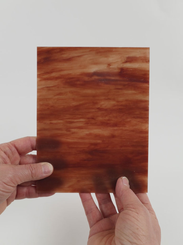 Video of the Sunset glass plate in translucent pink, 15x19cm, held up and tilted to show its pattern and transparency
