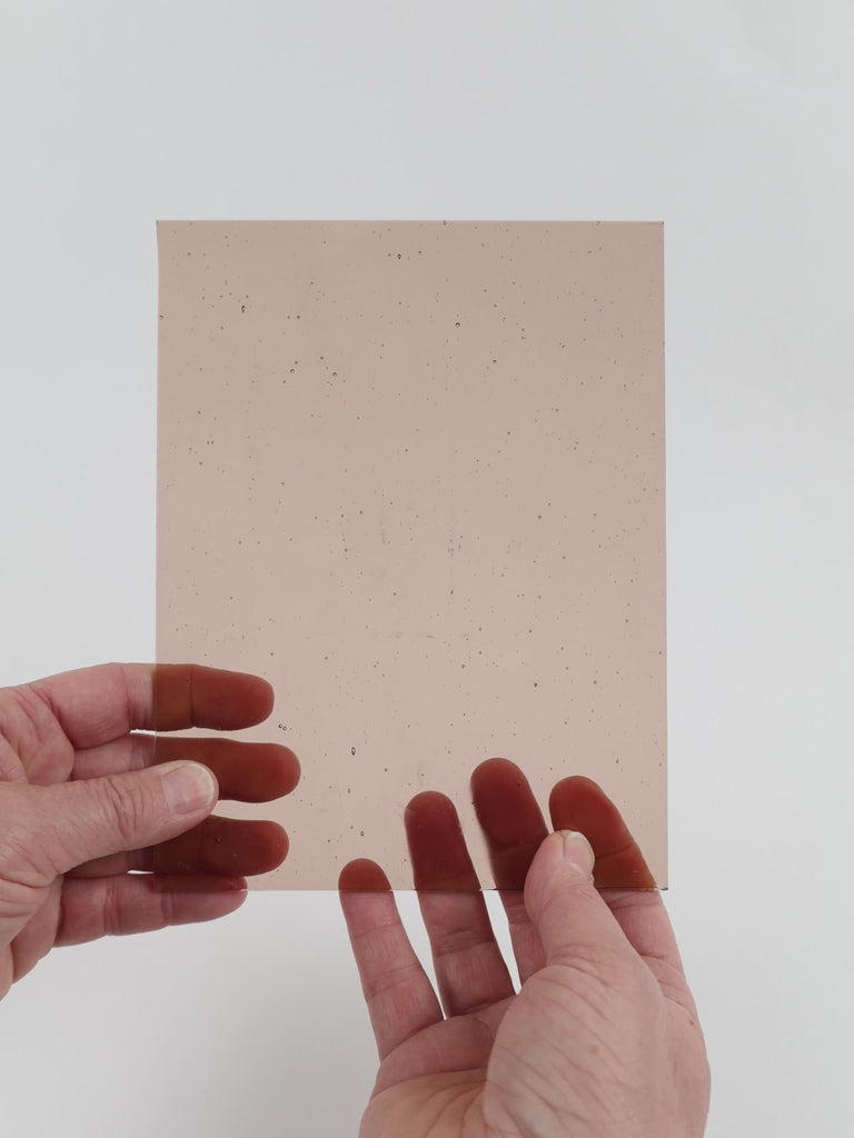 Video of the Taupe glass plate in transparent pink, 15x19cm, held up and tilted to show its pattern and transparency