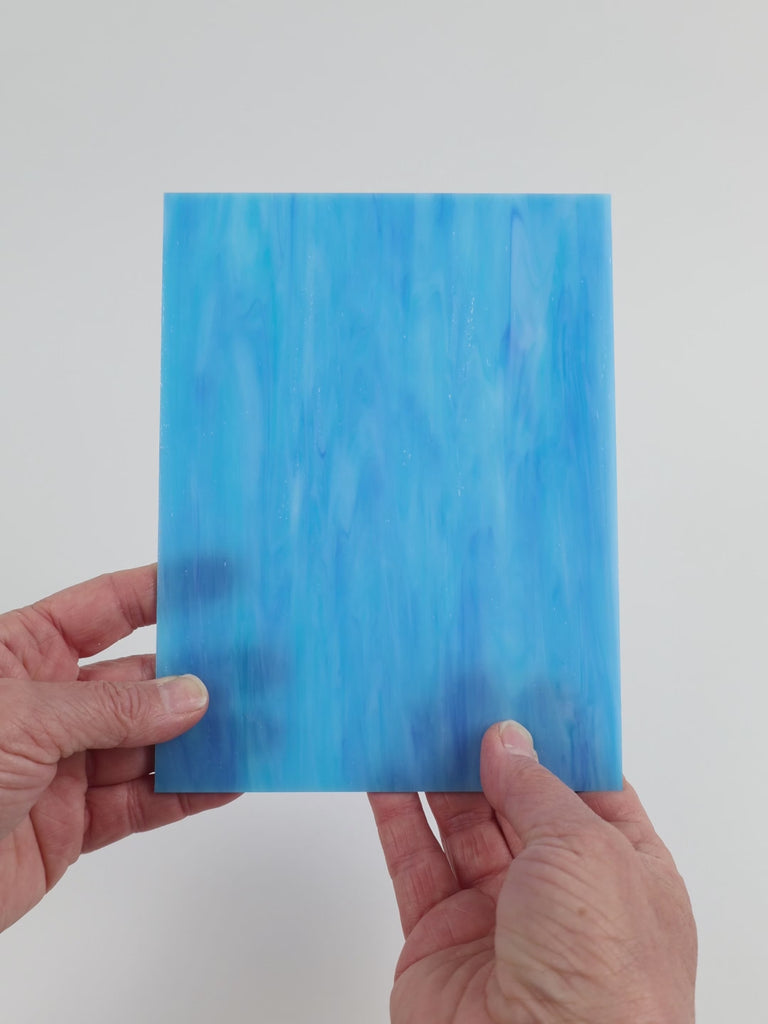 Video of the Blue Turquoise Wispy glass plate in translucent blue, 15x19cm, held up and tilted to show its pattern and transparency